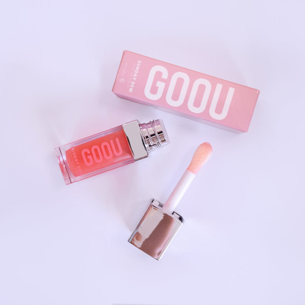GOOU Beauty Sunday dew lip oil gloss with applicator and pink packaging on a white background