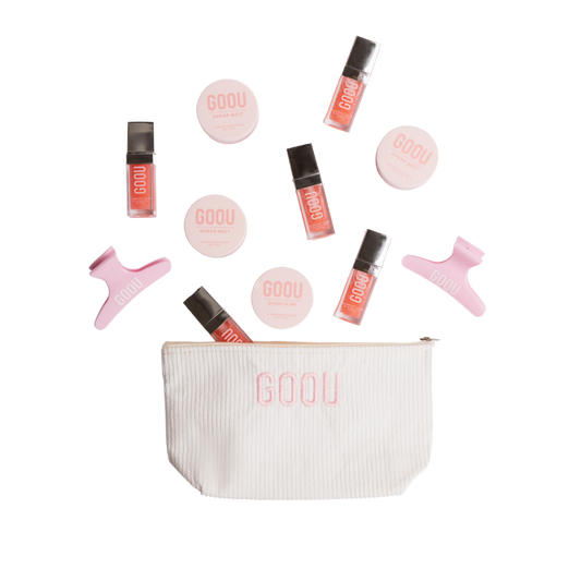 Goou Beauty cosmetic makeup beauty travel bag in white with pink logo featuring lip oil gloss, lip scrub, lip balm mask and pink hair clip grip on white background