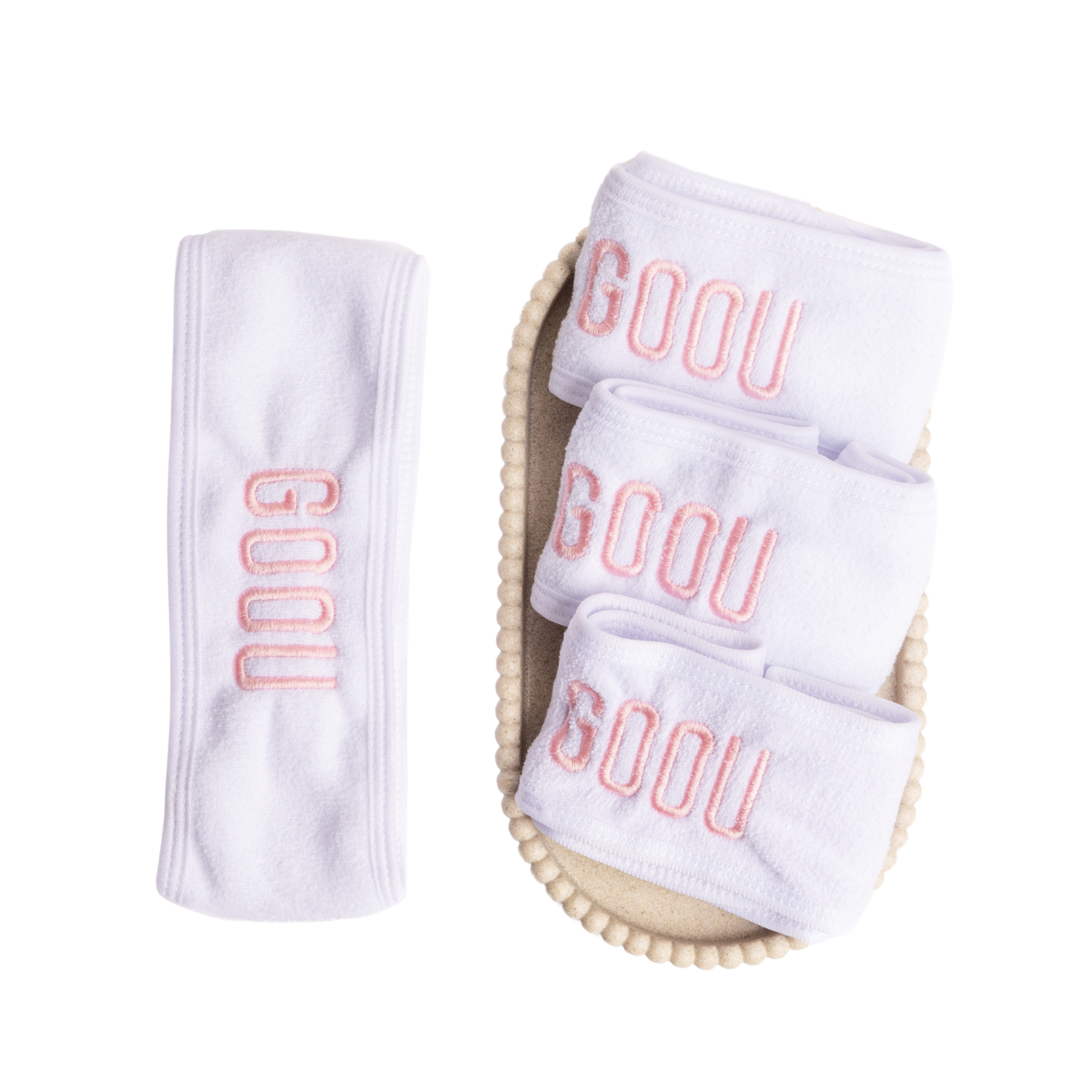 Goou Beauty white spa headband for makeup removing with pink logo on white background