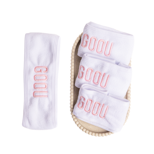 Goou Beauty white spa headband for makeup removing with pink logo on white background